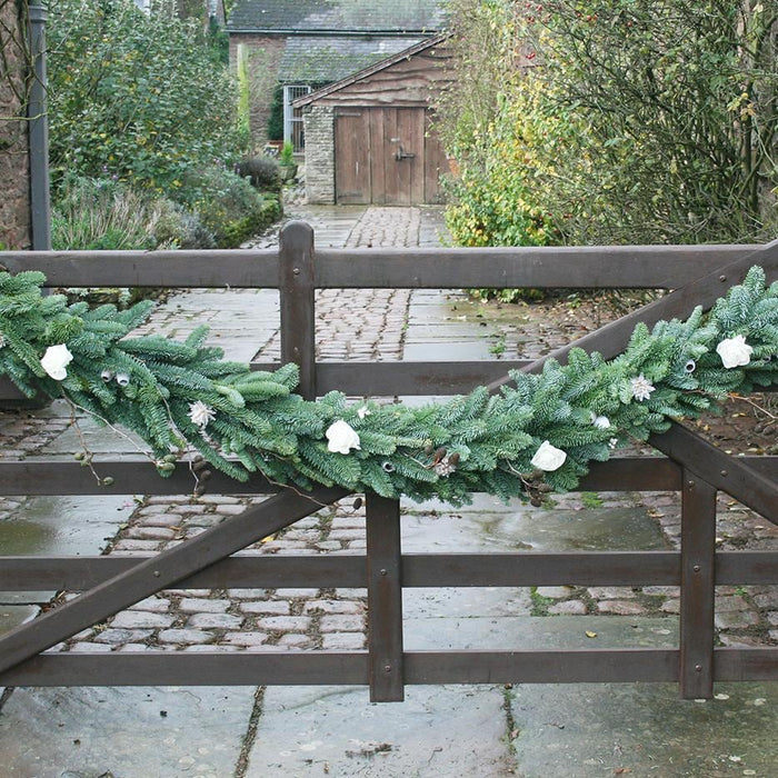 White Floral Garland on gate from Pines and Needles